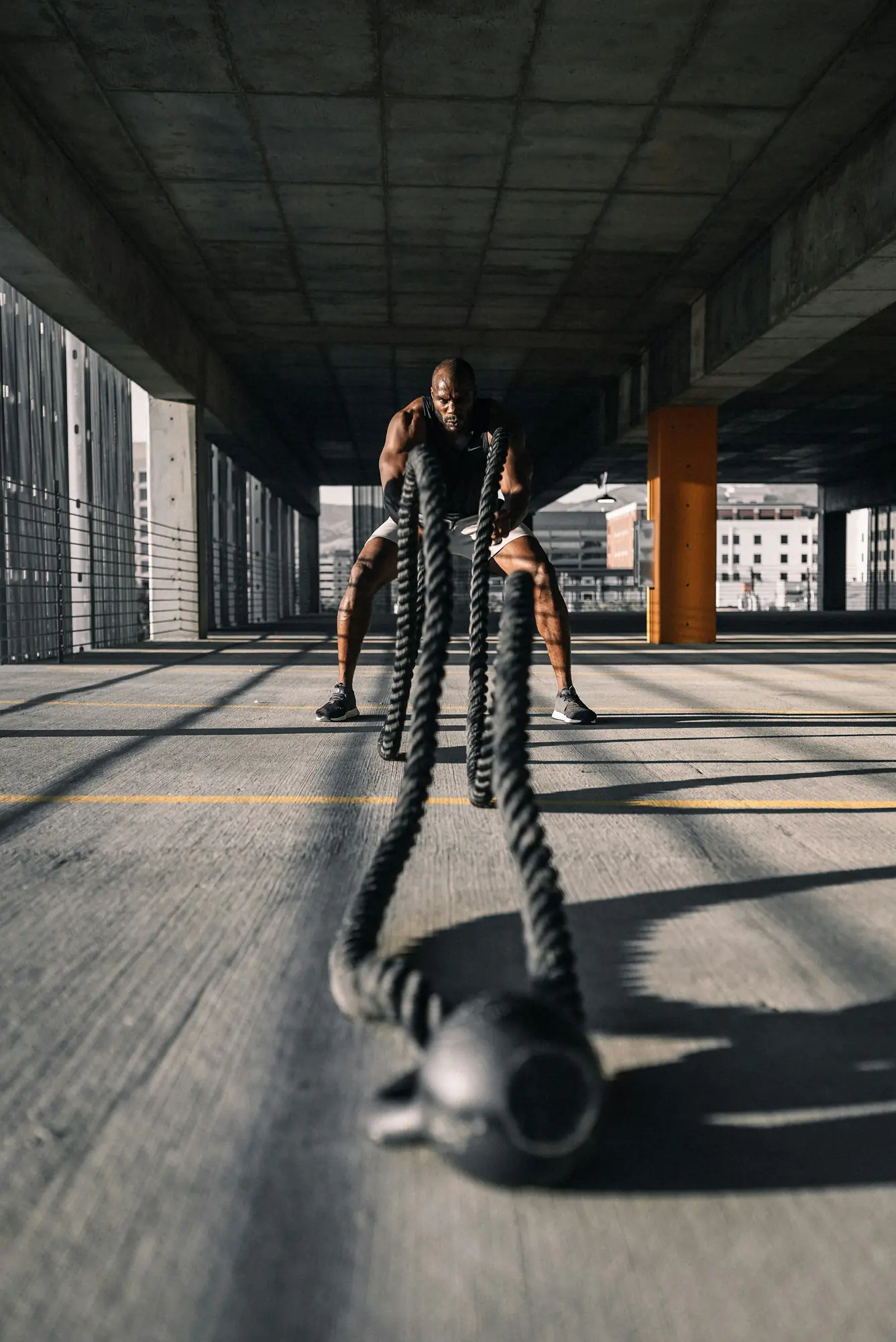 An athlete working battle ropes